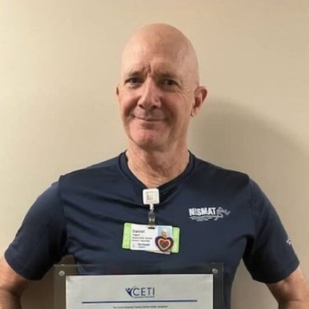 Dan Hogan holding his OncoVie Cancer Exercise Specialist certificate