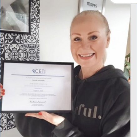 Danielle Novytarger holding her OncoVie Cancer Exercise Specialist certificate