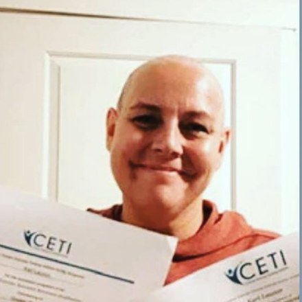 Kari Lauzon, physical therapist and yoga teacher, holding her CETI certificates